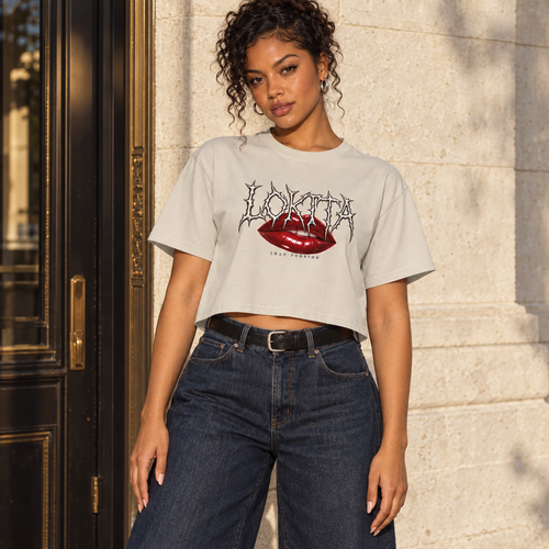Styled model mockup of the Bone LOKITA Lip Bite Crop Tee with red lips, spiky lettering and Jhay Foreign signature.